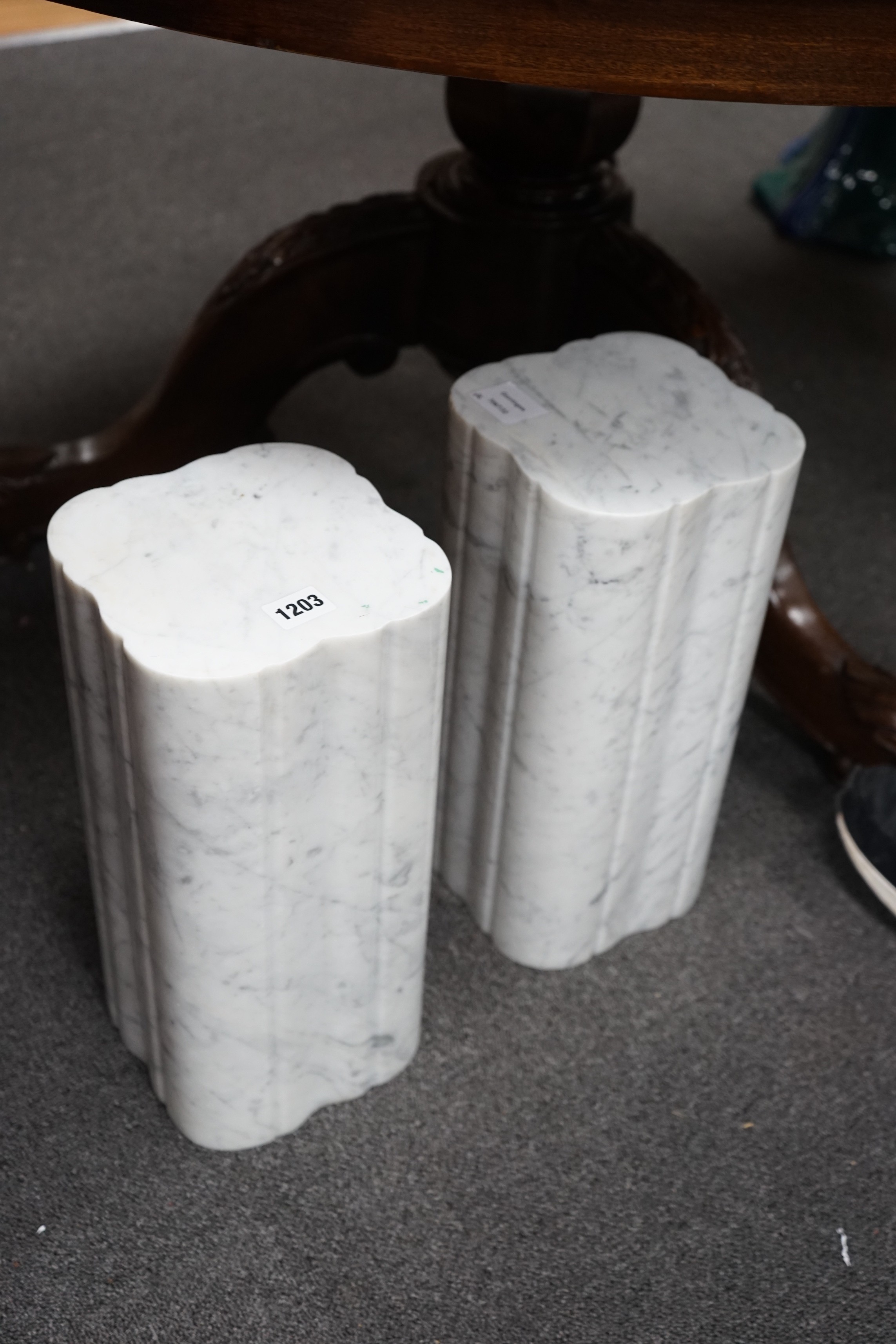 A pair of reconstituted white marble stands, height 38cm